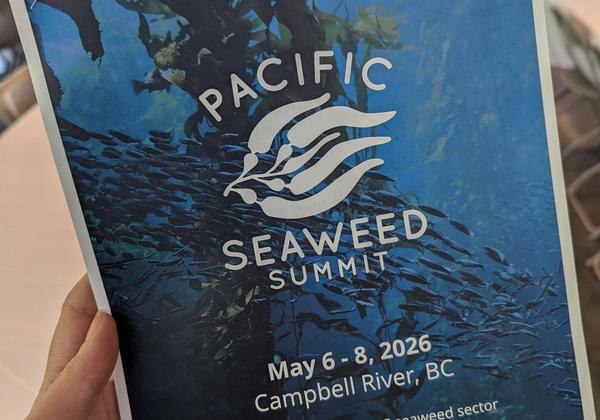A poster held in a hand at the seaweed summit